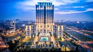 A large, illuminated hotel with a central courtyard and a pool. - Nam Cuong Nam Dinh Hotel (Nam Dinh)