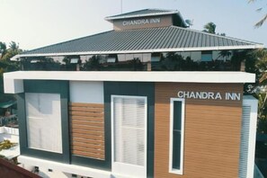 A modern building with the sign "CHANDRA INN" on the roof and on the side. - Chandra Inn (Kollam)