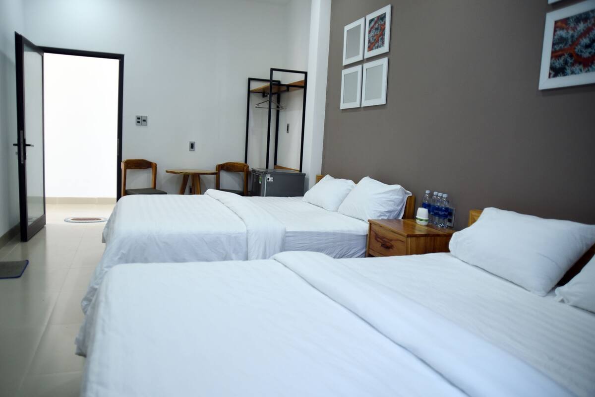 Deluxe Quadruple Room, 2 Queen Beds, Beach View | Minibar, desk, free WiFi, bed sheets