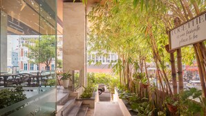 A modern hotel interior with a glass facade, a central staircase, and a sign reading "TOGETHER is our favorite place to be".