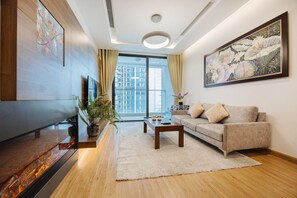Family Apartment, 3 Bedrooms, City View | Living area | 55-inch flat-screen TV with digital channels, LCD TV, fireplace - Shendo Vinhomes Metropolis (Hanoi)