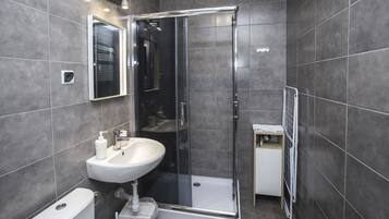 Shower, hair dryer, towels, shampoo