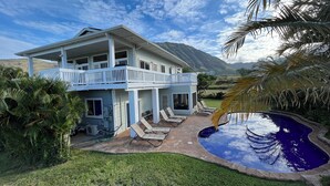 A two-story house with a balcony, a swimming pool, and a view of mountains. - 5 Bedroom, 6 Bath Home with Private Pool -  Ocean & Mountain Views (Waianae)