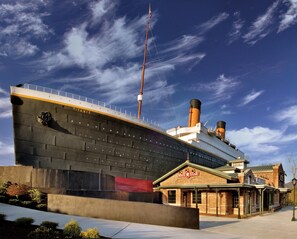 A large ship with the name "TITANIC" and a building labeled "WHITE STAR" in front of it. - Bear Crossing 301 (Pigeon Forge)