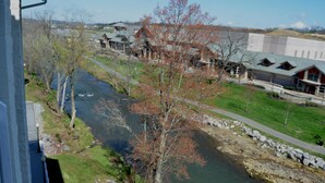 A river flowing through a town with buildings on both sides. - Bear Crossing 402 (Pigeon Forge)