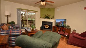 A living room with a fireplace, a television, and a sofa.