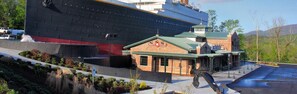 A large cruise ship docked next to a building with a sign reading "White Star."