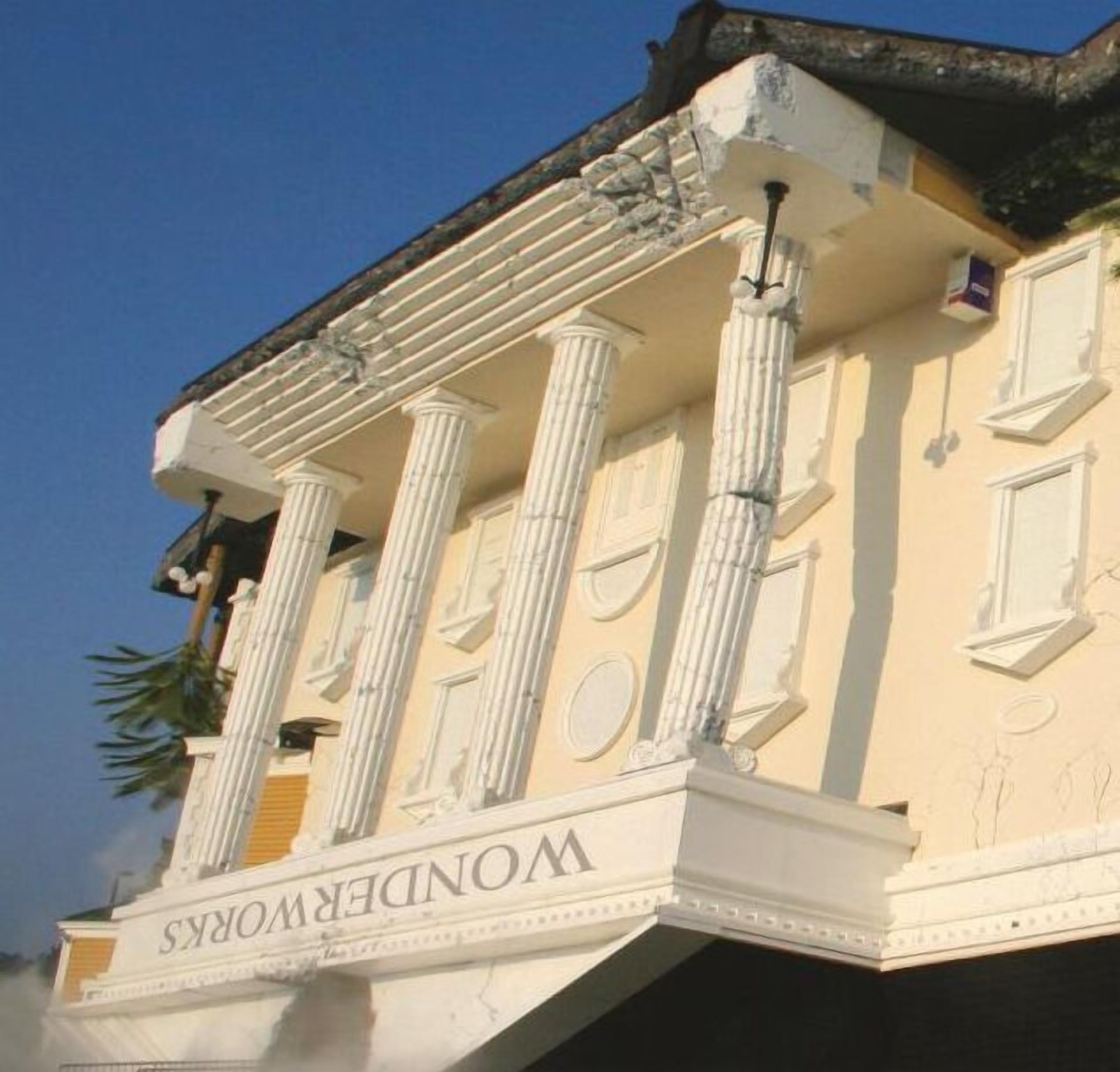 A building with classical architecture, featuring columns and a balcony with the inscription "WONDERWORKS".