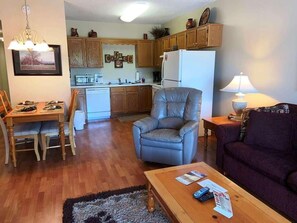 Cozy living space with a kitchenette, dining table, and sofa.