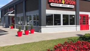 A building with a sign reading "BRICK & SPOON" and "BREAKFAST BRUNCH LUNCH". - Cedar Lodge 605 (Pigeon Forge)