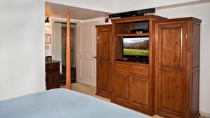 A bedroom with a bed, wooden wardrobe, and a television on top. - Cedar Lodge 603 (Pigeon Forge)