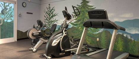 A gym with stationary bikes, an elliptical, and a treadmill.