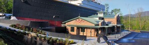 A large cruise ship docked at a port with a small brick building labeled "White Star" nearby. - Whispering Pines 341 (Pigeon Forge)