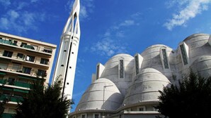 A modern building with a tall, narrow tower and multiple dome-shaped structures. - Villa Saint Hubert (Nice)