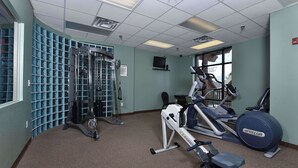 A gym with various exercise equipment, including a treadmill, elliptical, and weight machines. - 4002 Big Bear Resort (Pigeon Forge)