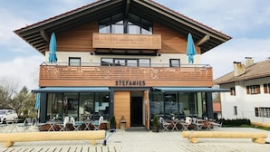 A two-story building with a wooden facade and a balcony. The name "STEFANIES" is visible above the entrance. - Stefanies Cafe Pension Culture (Bad Feilnbach)
