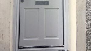 A white door with a glass panel and the number 20B above it. - Crossroad Bungalow (Paisley)