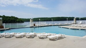A pool area with white lounge chairs and a view of a forested area. - 9104 Towers, Fantastic lake views!  STILL AVAILABLE FOR SHOOTOUT RACE WEEKEND (Osage Beach)