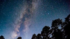 A log cabin with a sign reading "JONAH" under a starry night sky. - Corkins Lodge (Chama)