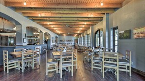 A spacious restaurant with wooden tables and chairs, a bar area, and large windows allowing natural light. - ‘Blue Jay Cottage' - Pittsburg Studio on Winery! (Pittsburg)