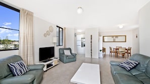 A modern living room with a TV, sofa, and coffee table. - Sundial 503, Hollingworth Street (Port Macquarie)