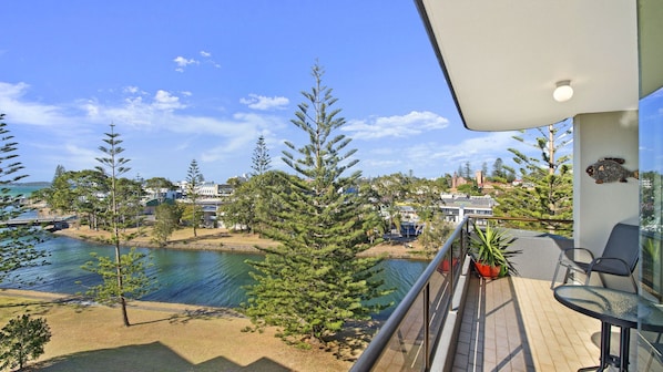A balcony with a view of a body of water, trees, and buildings in the distance. - Sundial 503, Hollingworth Street (Port Macquarie)