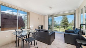 A balcony with a glass table, chairs, and a sofa. - Ocean Court 7, 13 Lord Street (Port Macquarie)