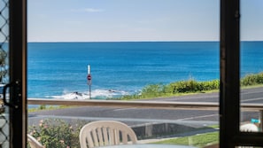A view of the ocean through a window, with a road and a 'NO ENTRY' sign visible. - Beachpark 10, 58 Pacific Drive (Port Macquarie)