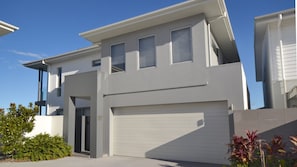 A modern two-story house with a garage, large windows, and a flat roof. - 4/84 The Anchorage, Port Macquarie (Port Macquarie)