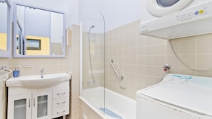A modern bathroom with a glass-enclosed shower, a white sink, and a bathtub. - Beachpark 56, 58 Pacific Drive (Port Macquarie)