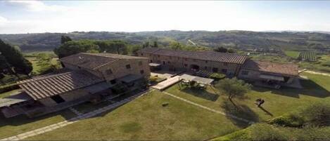 A large, historic building with multiple wings and a courtyard.