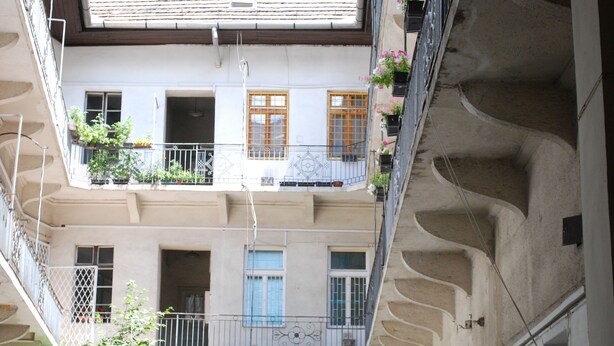 A multi-story building with balconies, some with plants. - Art Aldebaran: a magical feeling in the City Center with A/C! (VI. kerület)