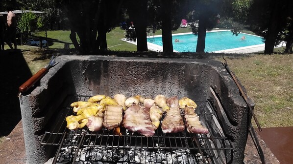 A barbecue grill with various meats being cooked outdoors. - Villa park pool exclusively vacation private parties groups up to 35 seats (sansepolcro (arezzo))