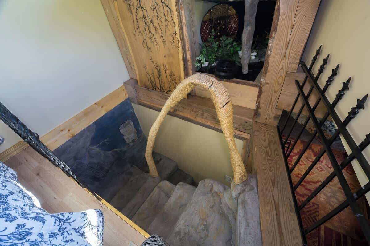 A staircase with a woven basket, wooden steps, and a metal railing.