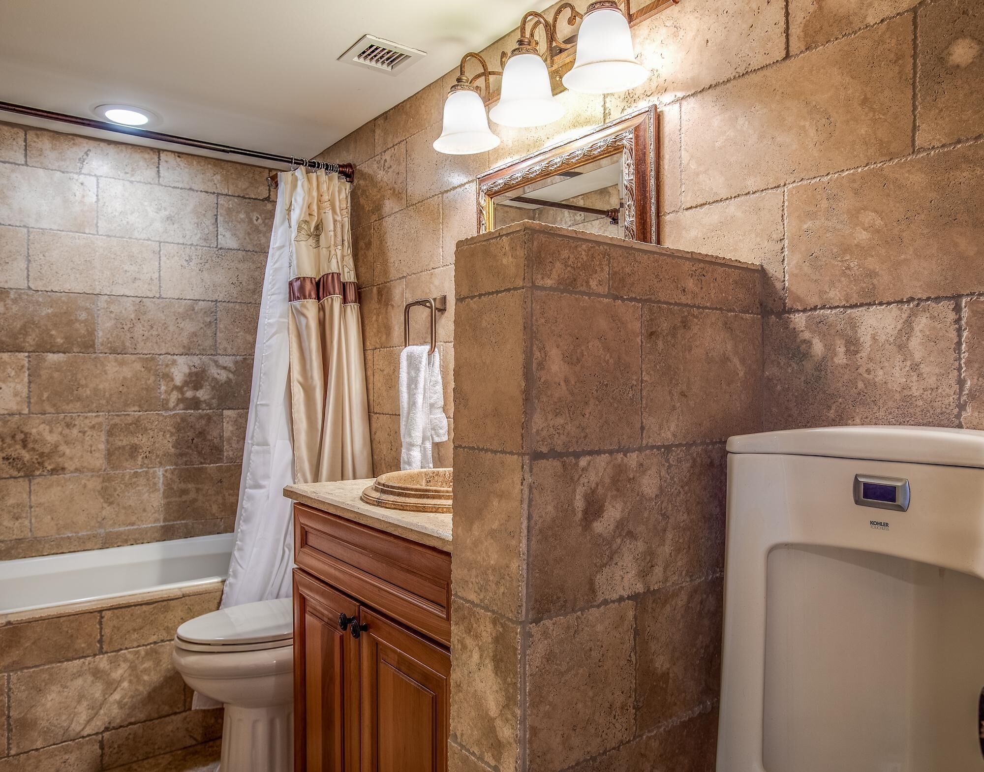 A bathroom with a toilet, sink, and bathtub.