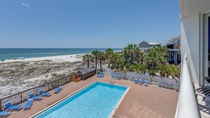 A pool area with a view of the beach and ocean. - Gulf Views! (Pensacola)