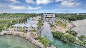 A coastal hotel with a marina, a dock, and a beach area.