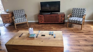 Relax in this inviting living room with a coffee table, side table, and comfortable armchairs.
