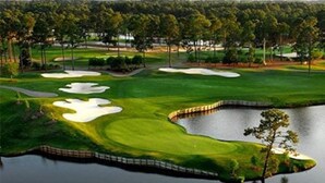 A golf course with sand bunkers, a pond, and a forest in the background. - Audrey House, Pet Friendly, Blocks from Beach (NORTH MYRTLE BEACH)