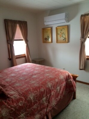 Enjoy a comfortable stay in this cozy room featuring a single bed, a small table, and artwork on the walls.