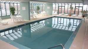 An indoor swimming pool with a 'NO DIVING' sign, surrounded by lounge chairs and tables, and large windows. - Magnificent Bay View!!! Luxurious Condo, Your Home-Away-From-Home, Makai #316 (Ocean City)