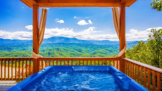A hot tub with a wooden deck and a scenic mountain view. - 🐻Awesome View: Mtn Views! Secluded, Hot Tub, WiFi, Near Attractions!🗻 (Sevierville)