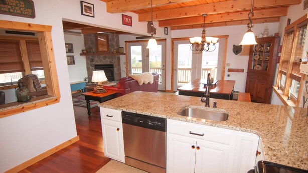 A kitchen with granite countertops, stainless steel appliances, and white cabinetry. - Three Bears in the Valley (Davis)