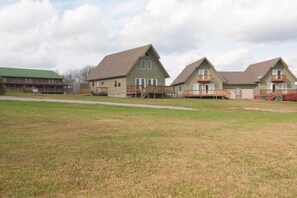 A row of two-story houses with a grassy lawn in front.