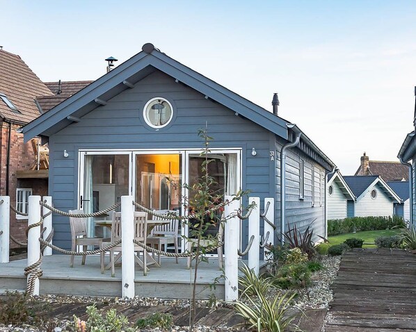 A single-story house with a front porch, a circular window above the entrance, and a visible number '31A'.