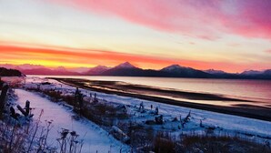 A snowy landscape with a body of water and mountains in the distance. - The Lookout Lodge on Bishop's Beach with Spectacular views of Kachemak Bay! (Homer)