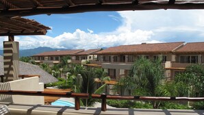 A resort balcony with a view of multiple buildings, palm trees, and a clear sky. - Executive 2 bed, 2 bath, Penthouse, Paradise Village, el Tigre, Isla Palmares (Nuevo Vallarta)