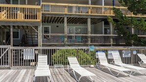 A multi-story building with a wooden deck and a lifeguard station. - Corolla Condo: 350 Ft to Beach, Community Pool Access at Indian Summer Condos (Corolla)
