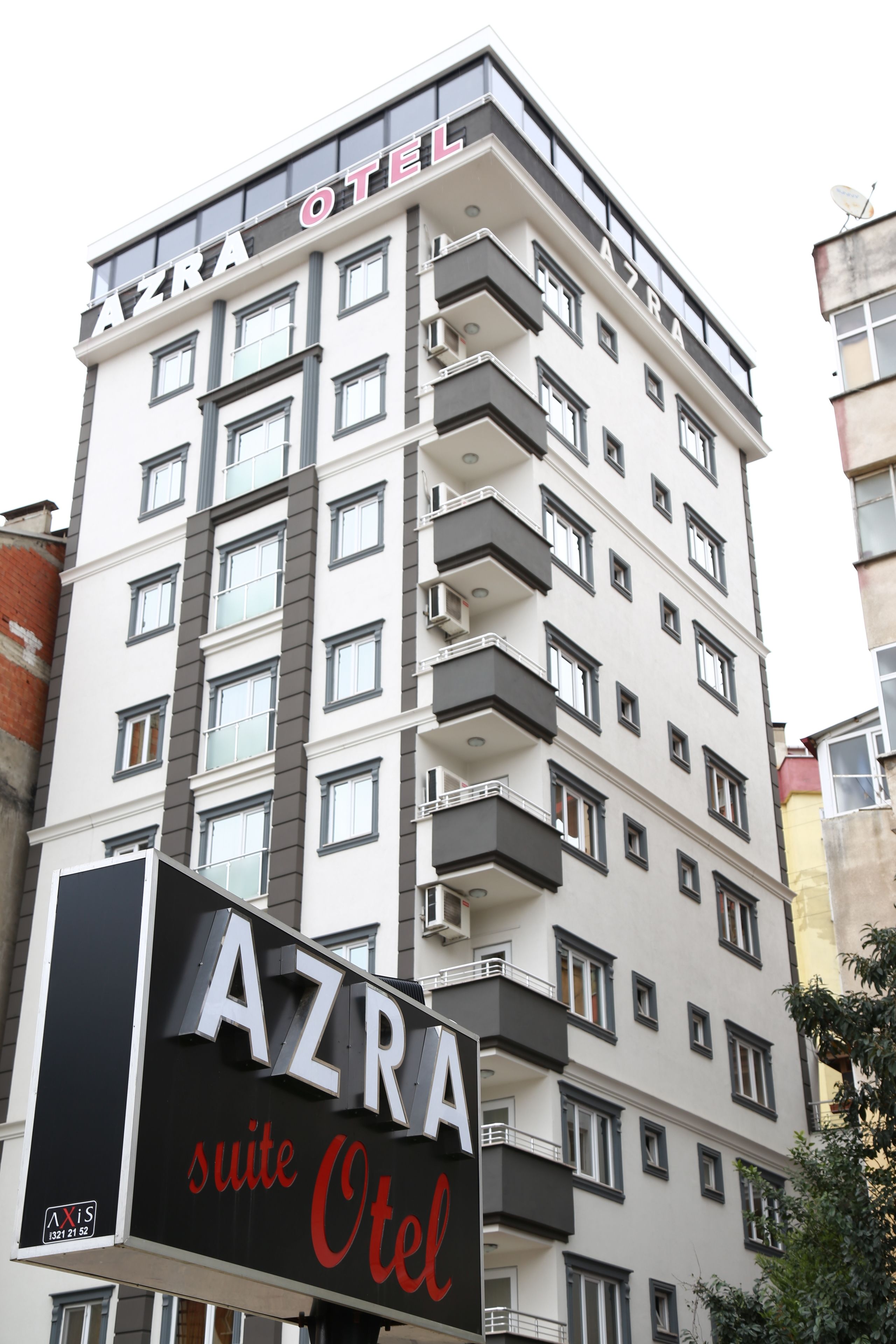 A multi-story building with the sign "AZRA OTEL" indicating it is a hotel.