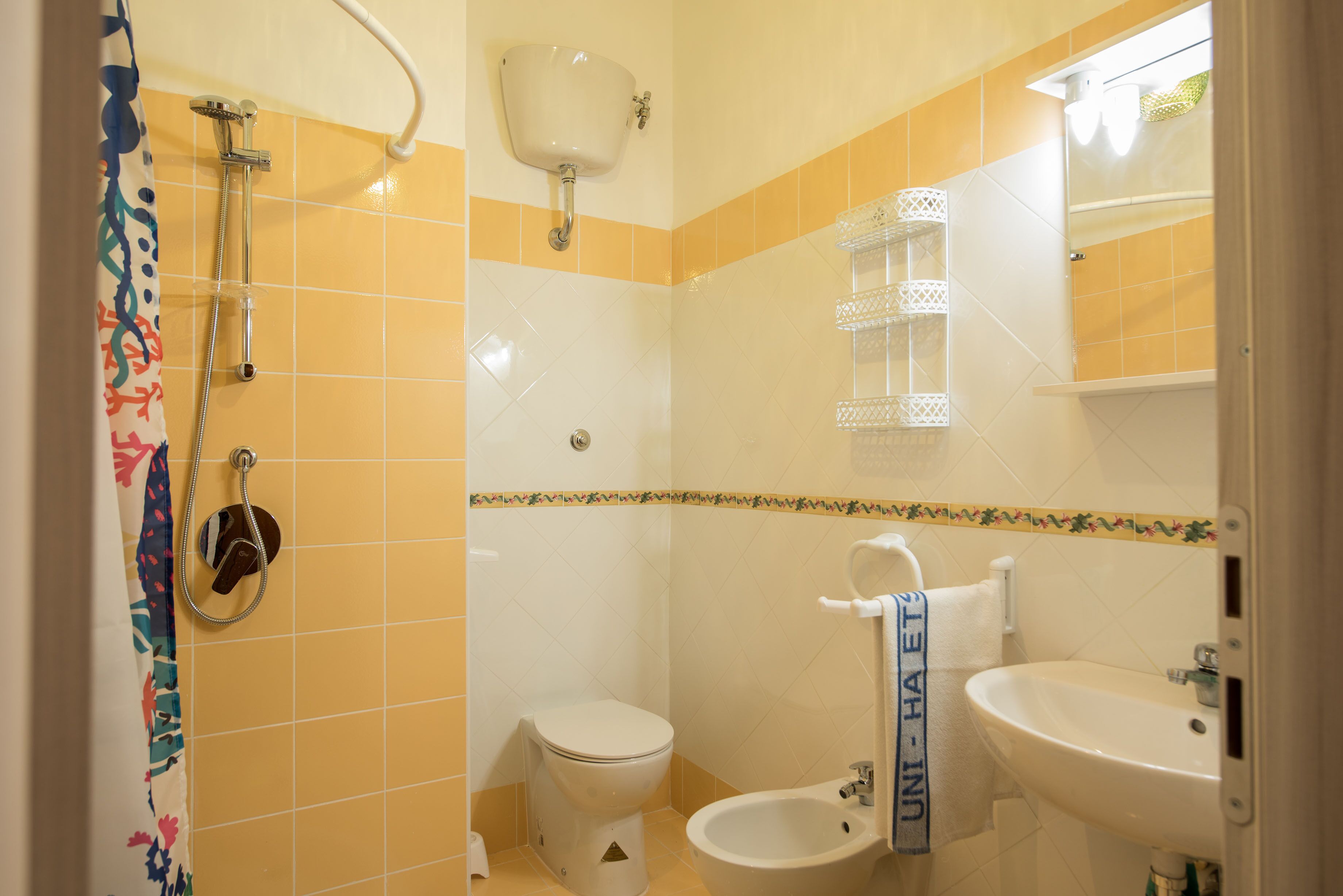 A bathroom with a toilet, bidet, and sink.